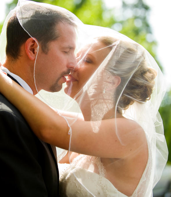 Bride and groom kissing.