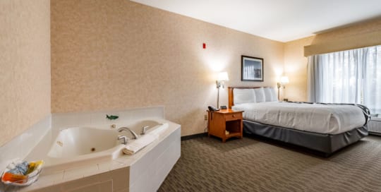 Hotel room with king bed and Jacuzzi tub.