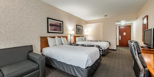 Hotel suite with two queen beds.